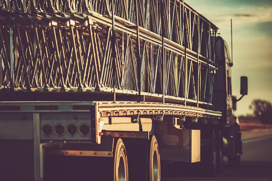 Heavy Duty Crane Frame Transport on a Semi Truck. Ground Transportation Industry Theme. American Highway. Trucking industry concept.