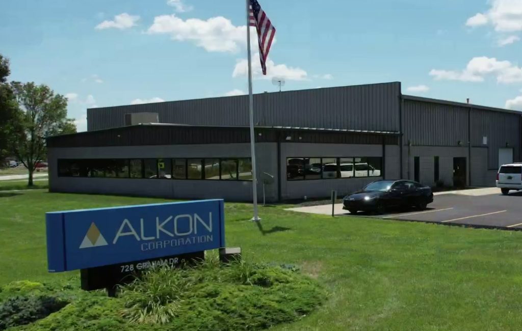 Front of Alkon Building with sign.